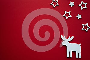 Christmas background.Reindeer and stars on red background.