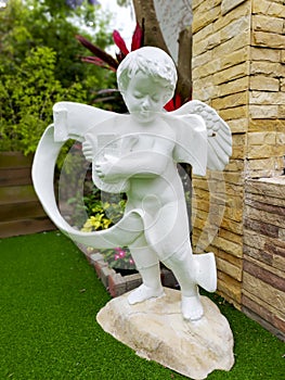 White statue of Cupid, the god of love.
