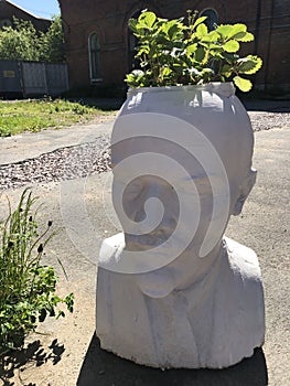 White statue of leader Lenin in the garden