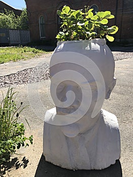 White statue of leader Lenin in the garden