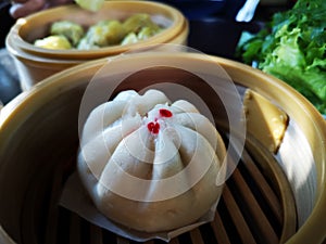 White steam chinese pork bun in wooden container sold street market Thailand