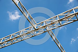 White steel cross structure on blue sky