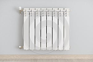 White steel heating radiator on the wall