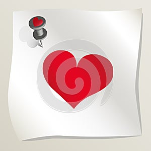 White sticky note with red heart image attached to a wall by a drawing pin. Sheet of paper with red heart. Happy Valentine`s day.