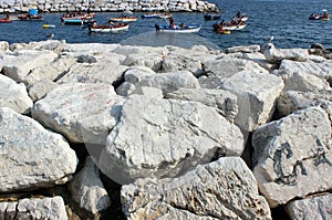 White stone beach and vacationers on boats photo