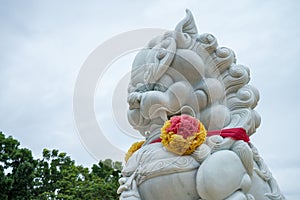 White stone Chinese guardian lion in Chinese temple, Kanchanaburi Thailand