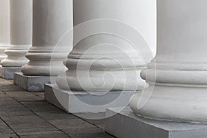 White stone columns of the old building. The facade of the theater