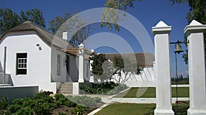 A white stone cottage with reed roof