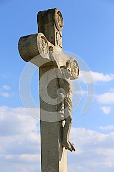 White stone cross against natural bue sky
