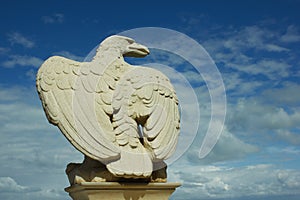 White stone eagle against the blue sky