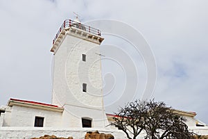 White Stone Lighthouse Tower With Overcast Sky