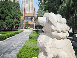 White stone lion guarding the entrance to the Confucius temple