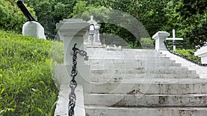 A white stone staircase rises to the hill in the park.