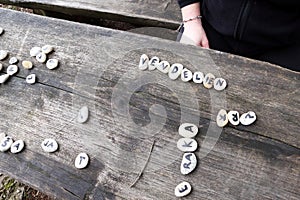 White stones with letters. Composing words from letters.