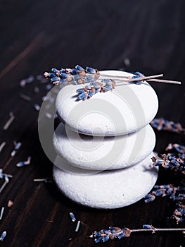 White stones stack, zen, spa, near dry lavender branches, on a wooden background