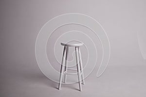White stool with shadow on white background. Location in studio with tabouret on white background