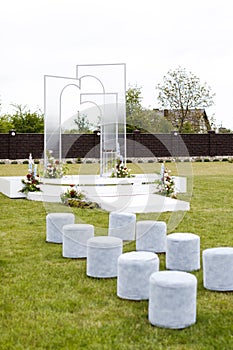 White stools on lush green field