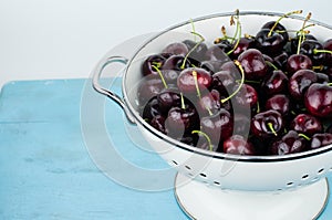 White strainer with cherries