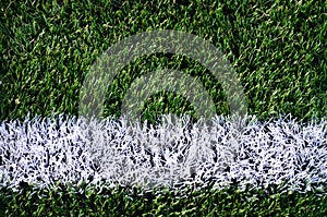 White stripe on a bright green artificial grass soccer fiel