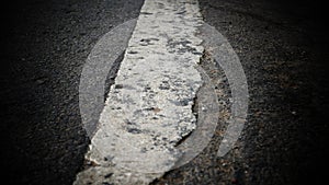 White stripe road markings on the asphalt road.