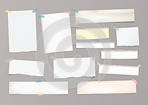 White striped note paper, copybook, notebook sheet stuck with adhesive tape on gray background.