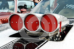 White stripes on the hood and turbo supercharger with red drosels on american the muscle car