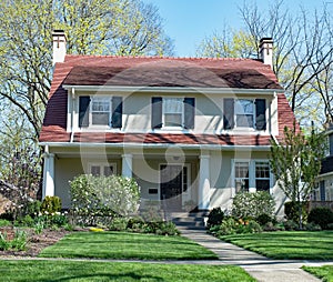 White Stucco House with Red Gambrel Roof photo