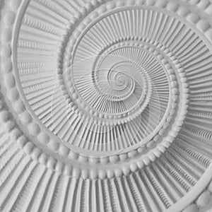 White stucco moulding plasterwork spiral abstract fractal pattern background. Plaster abstract spiral effect background element