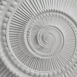 White stucco moulding plasterwork spiral abstract fractal pattern background. Plaster abstract spiral effect background element photo