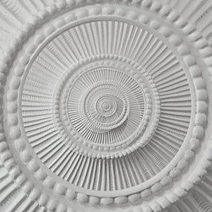 White stucco moulding plasterwork spiral abstract fractal pattern background. Plaster abstract spiral effect background element photo