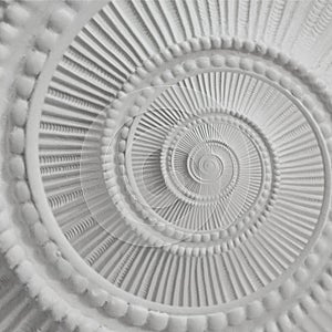 White stucco moulding plasterwork spiral abstract fractal pattern background. Plaster abstract spiral effect background. White spi photo