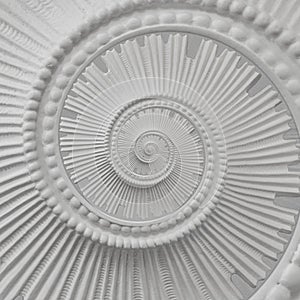 White stucco moulding plasterwork spiral abstract fractal pattern background. Plaster abstract spiral effect background elements photo