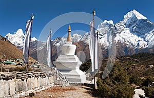 White stupa, prayer flags and himalayas