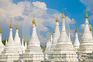 White stupas of the Sanda Muni pagoda. Mandalay