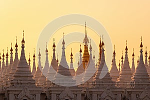 White stupas of Sanda Muni Pagoda at sunset in Mandalay Burma Myanmar