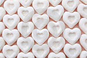 White sugar hearts on light background