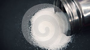White sugar spilled from a bottle