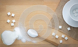 White sugar and sugar cubes in wood spoon on wooden background with copy space,Coffee mug with sugar cubes