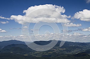 White summer clouds overt the mountains