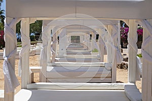 White sun canopy with mattress on luxury sand beach in tropical resort in Red Sea coast in Egypt, Africa