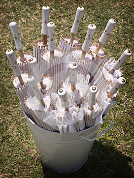 White Sun Parasols in A White Bucket