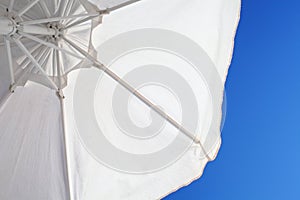 White sunshade on th background of blue sky