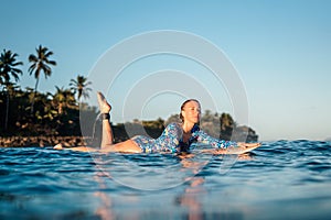 White surf board in blue ocean pictured from the water in Encuentro beach photo