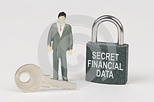 On a white surface there is a figurine of a businessman, a key and a lock with the inscription - Secret financial data