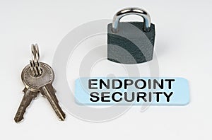 On a white surface there is a lock, keys and a blue sign with the inscription - Endpoint security