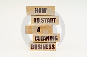 On a white surface are wooden blocks with the inscription - How To Start a Cleaning Business