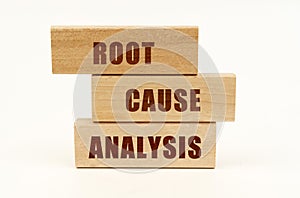 On a white surface are wooden blocks with the inscription - Root Cause Analysis