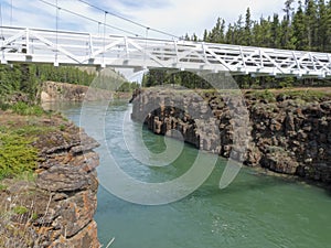 White suspension bridge across Miles Canyon Yukon
