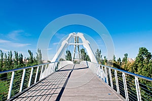 White suspension bridge in Valencia Bioparc under blue sky photo