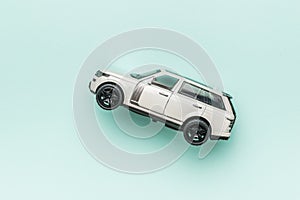 A white SUV on a light blue background. The concept of auto mania